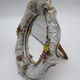 Antique porcelain mirror from Dresden with relief flowers and rococo decoration.