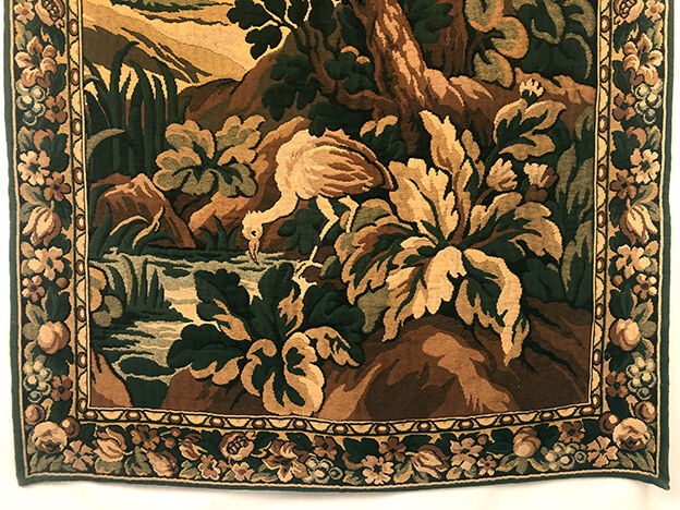Tapestry decorated with a pink flamingo in a green landscape, woven by hand