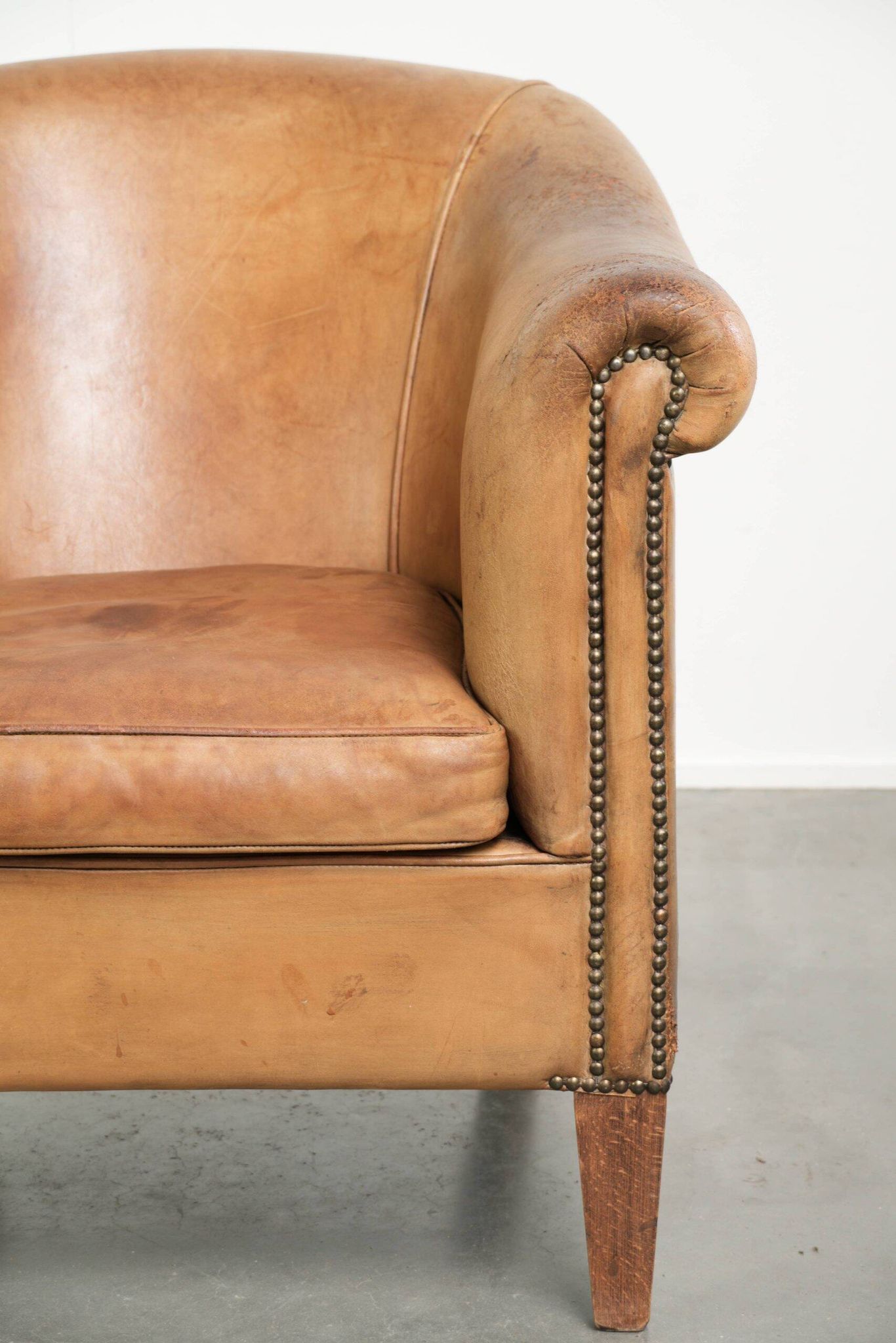Comfortable sheepskin club armchair in a cognac colour