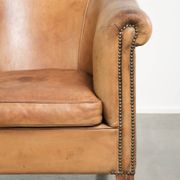 Comfortable sheepskin club armchair in a cognac colour
