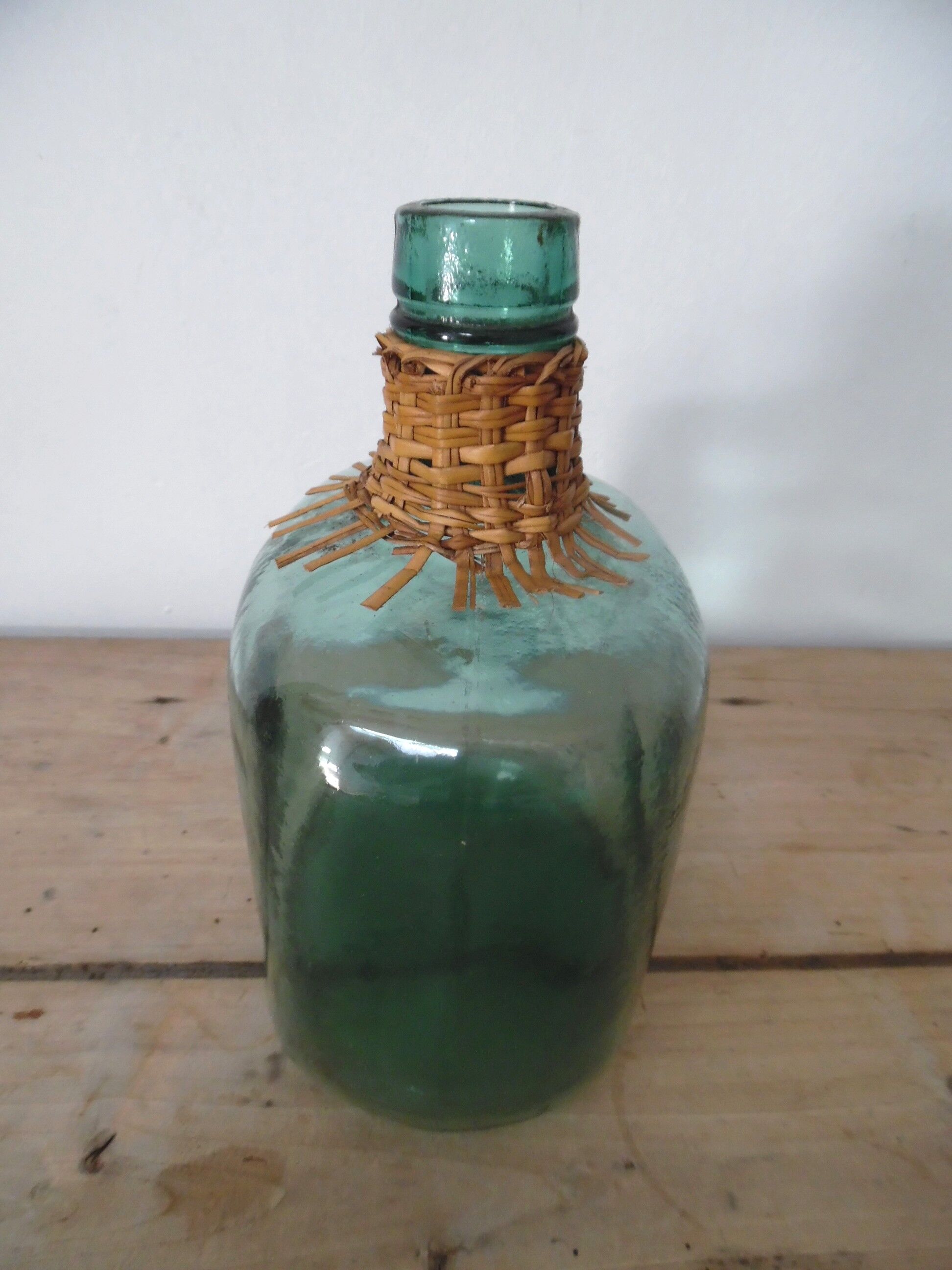 Demijohn with her rattan necklace