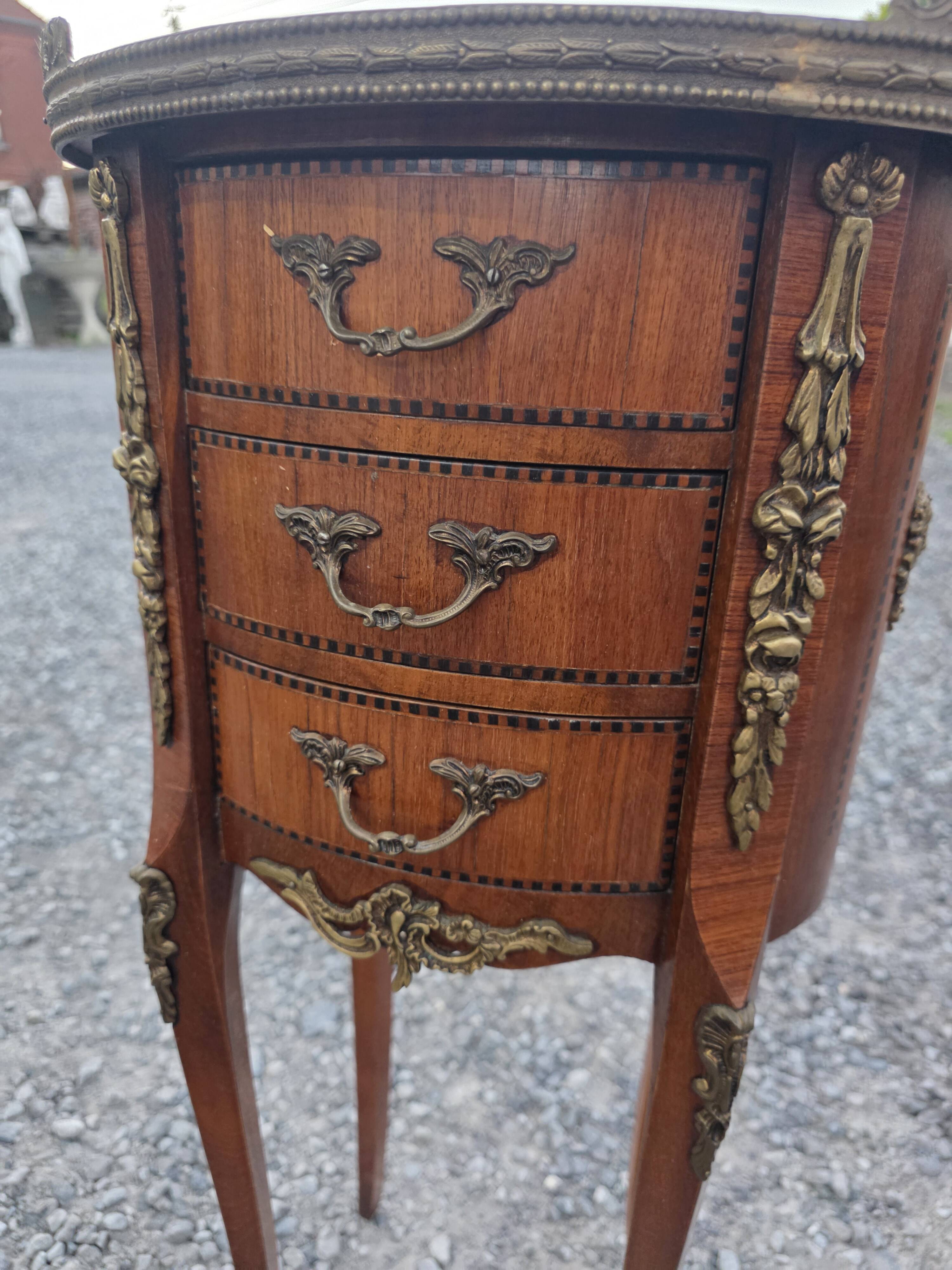 Oval bedside table in Louis XV style with marquetry.