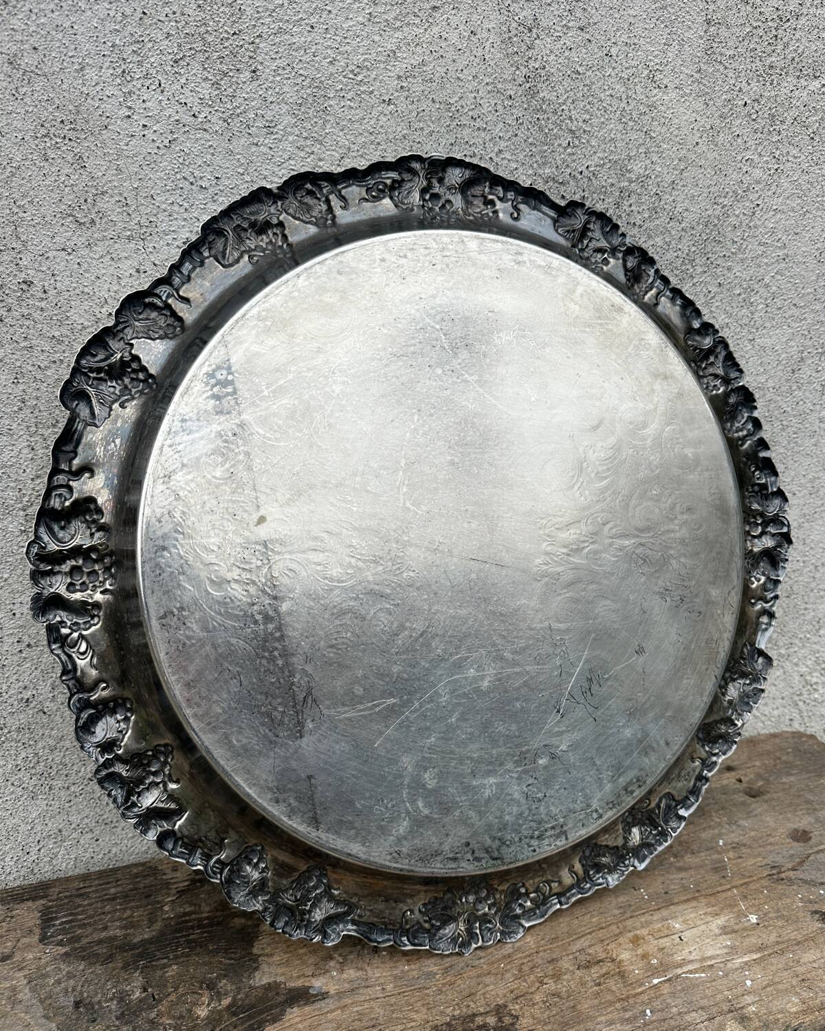 Antique round silver serving platter, grape motifs.