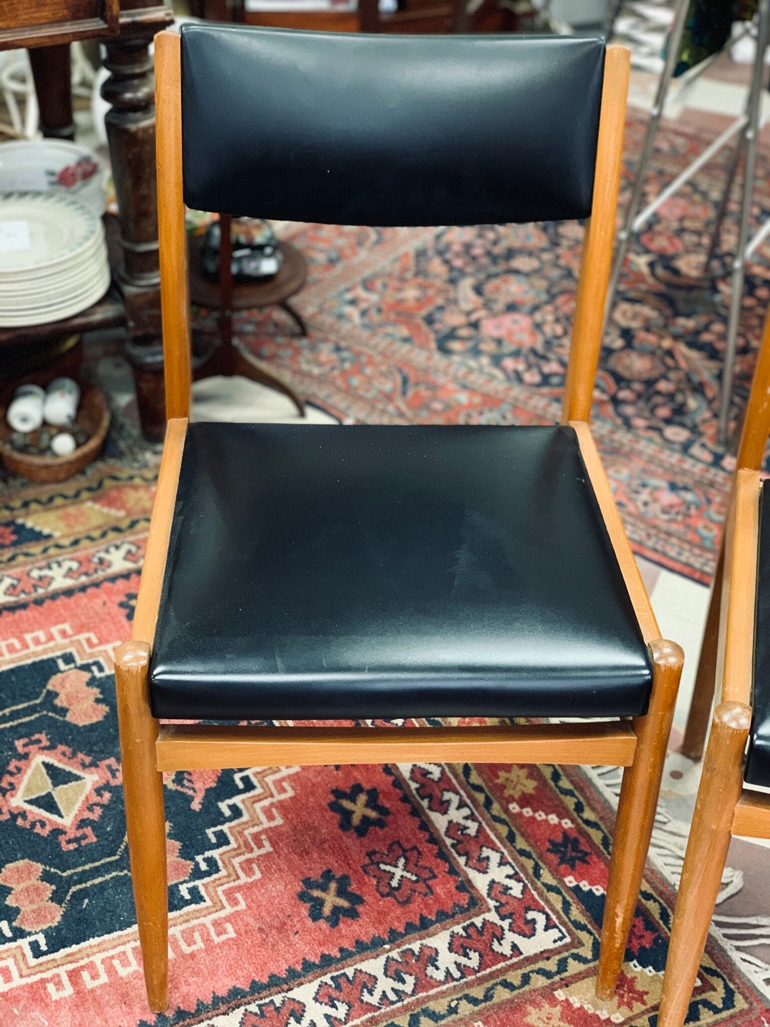 2 Scandinavian-style natural wood chairs, black trim