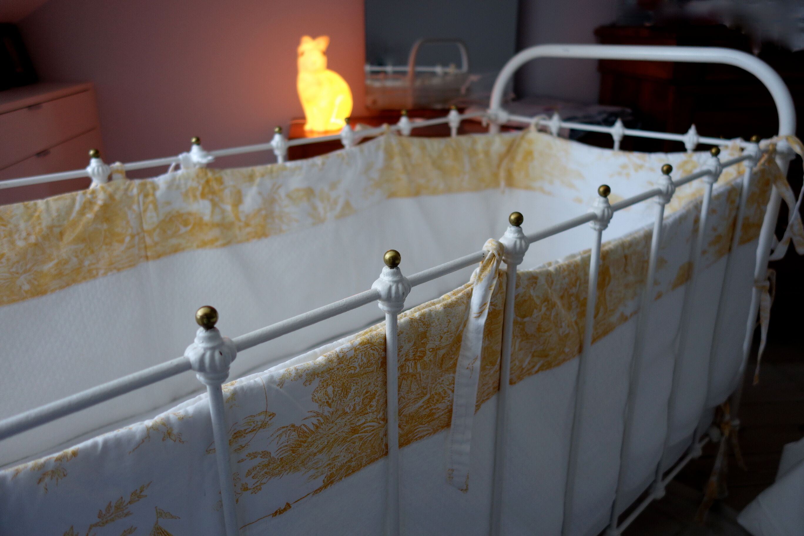 Old bed in wrought iron and brass balls