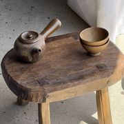 Small stool, oval solid teak side table with curved legs in wabi-sabi style.
