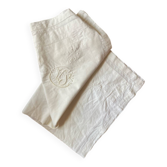 Antique pillowcase in white cotton embroidered with V J monogram.