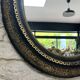 Miroir ancien 61,5/53,5cm ovale époque Napoléon III, noir et doré