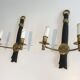 Pair of black lacquered bronze wall sconces decorated with lion heads