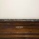 Antique wooden chest of drawers with a marble top.