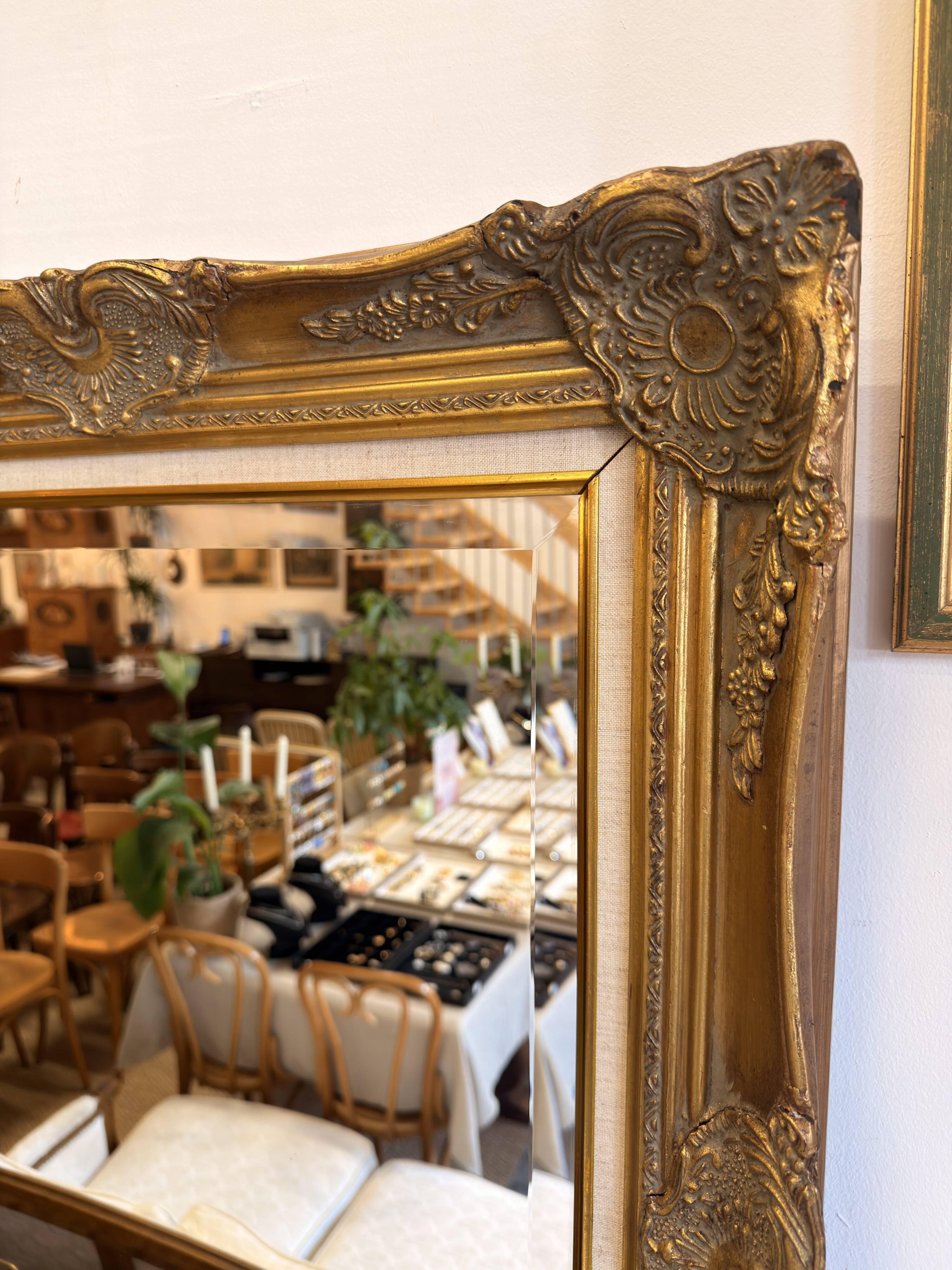 Golden wooden mirror in Louis XV style