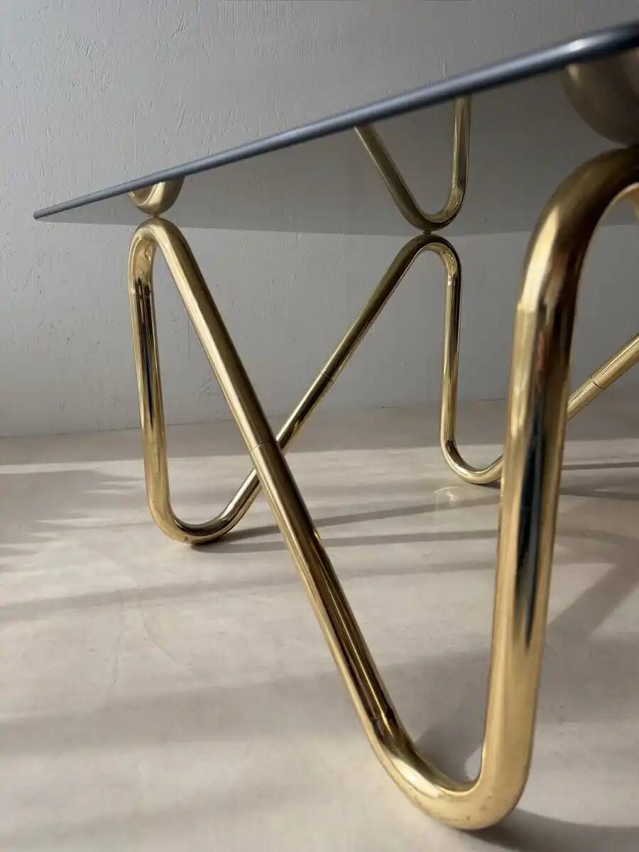 Coffee table with smoked glass and curved metal base