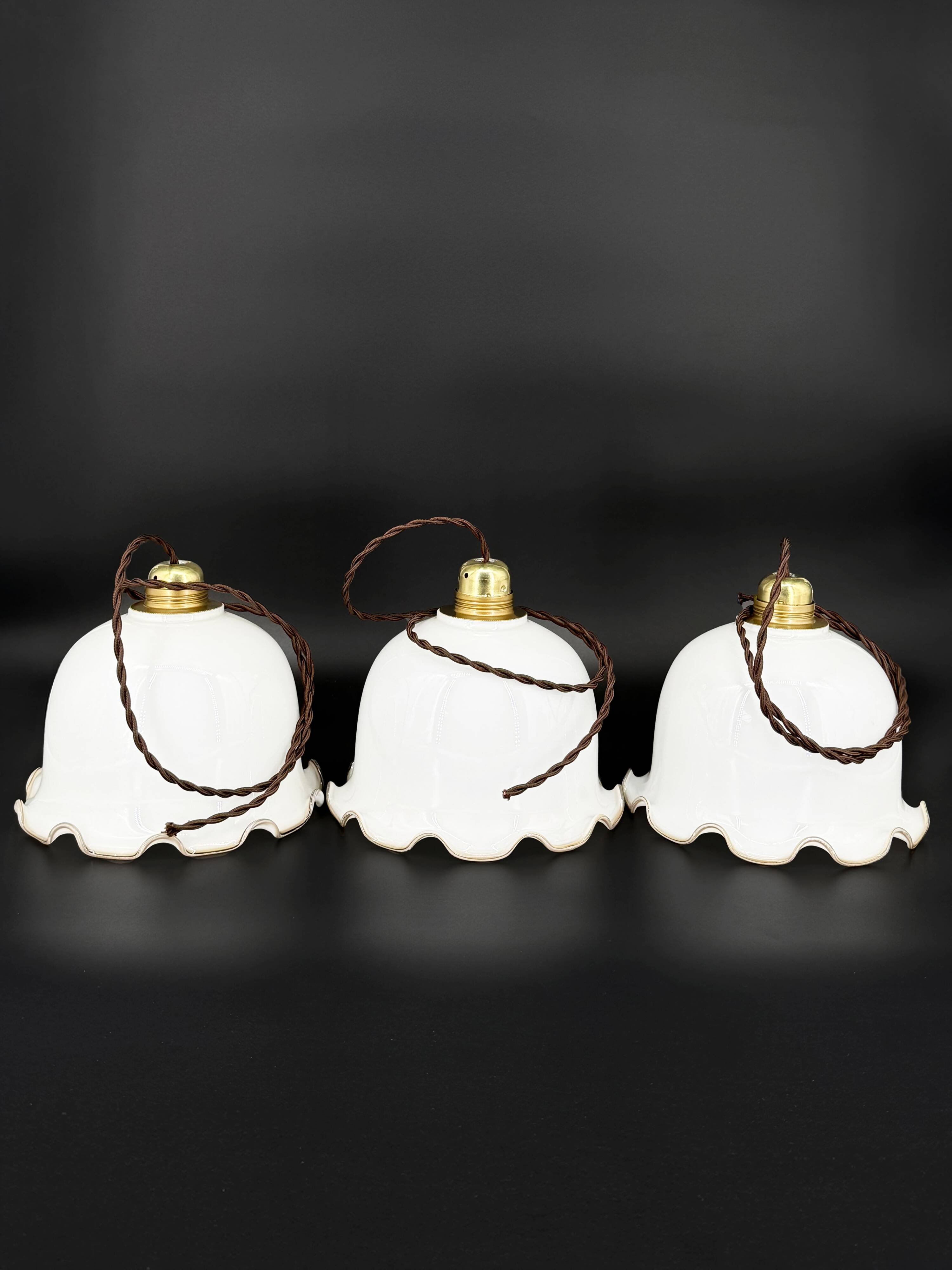 Set of 3 vintage bell-shaped pendants in white opaline with brown trim.