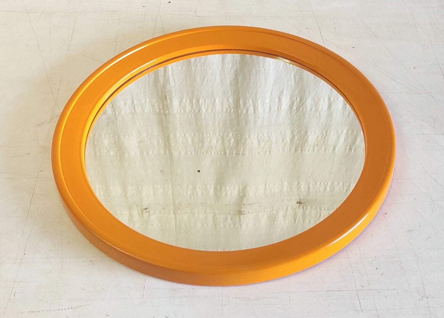 Round orange plastic mirror - 1970s