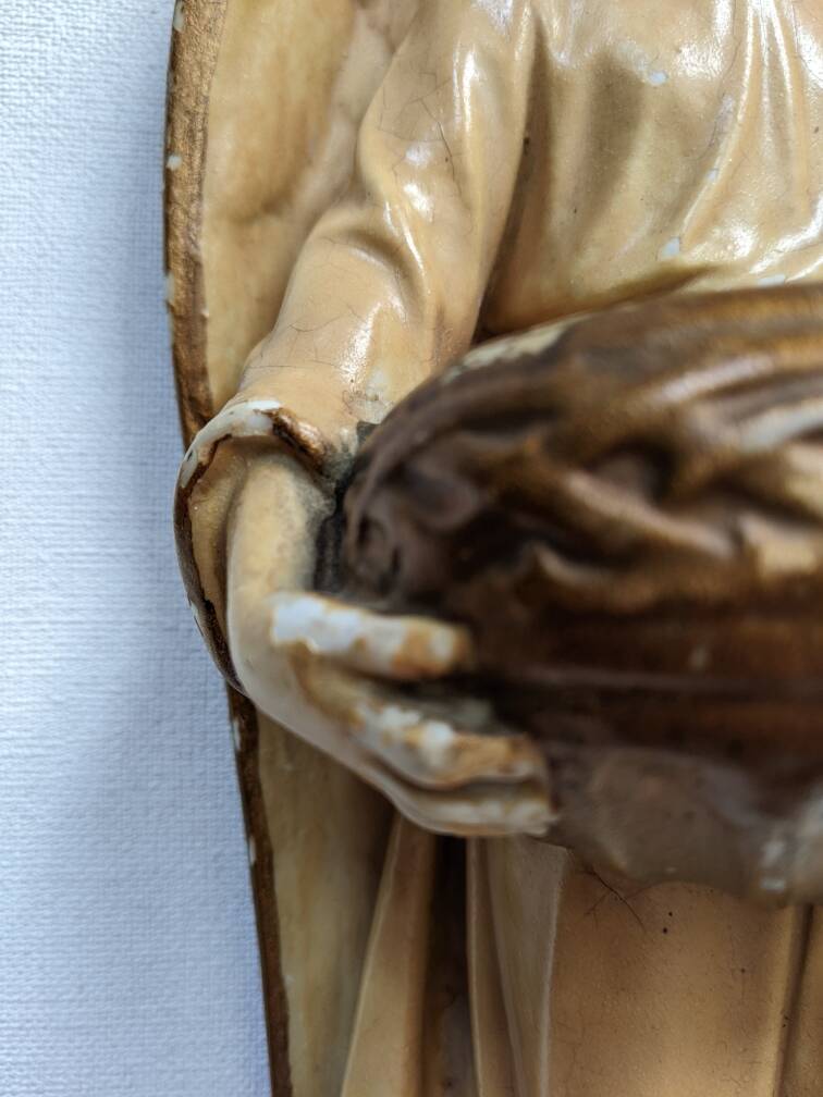 Antique ceramic holy water font with winged angel, religious object, country decoration