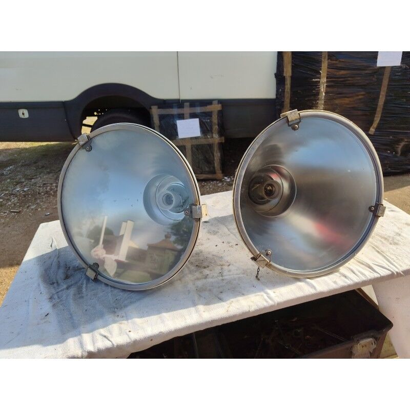 Pair of industrial pendant lights in aluminium and glass.