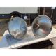 Pair of industrial pendant lights in aluminium and glass.