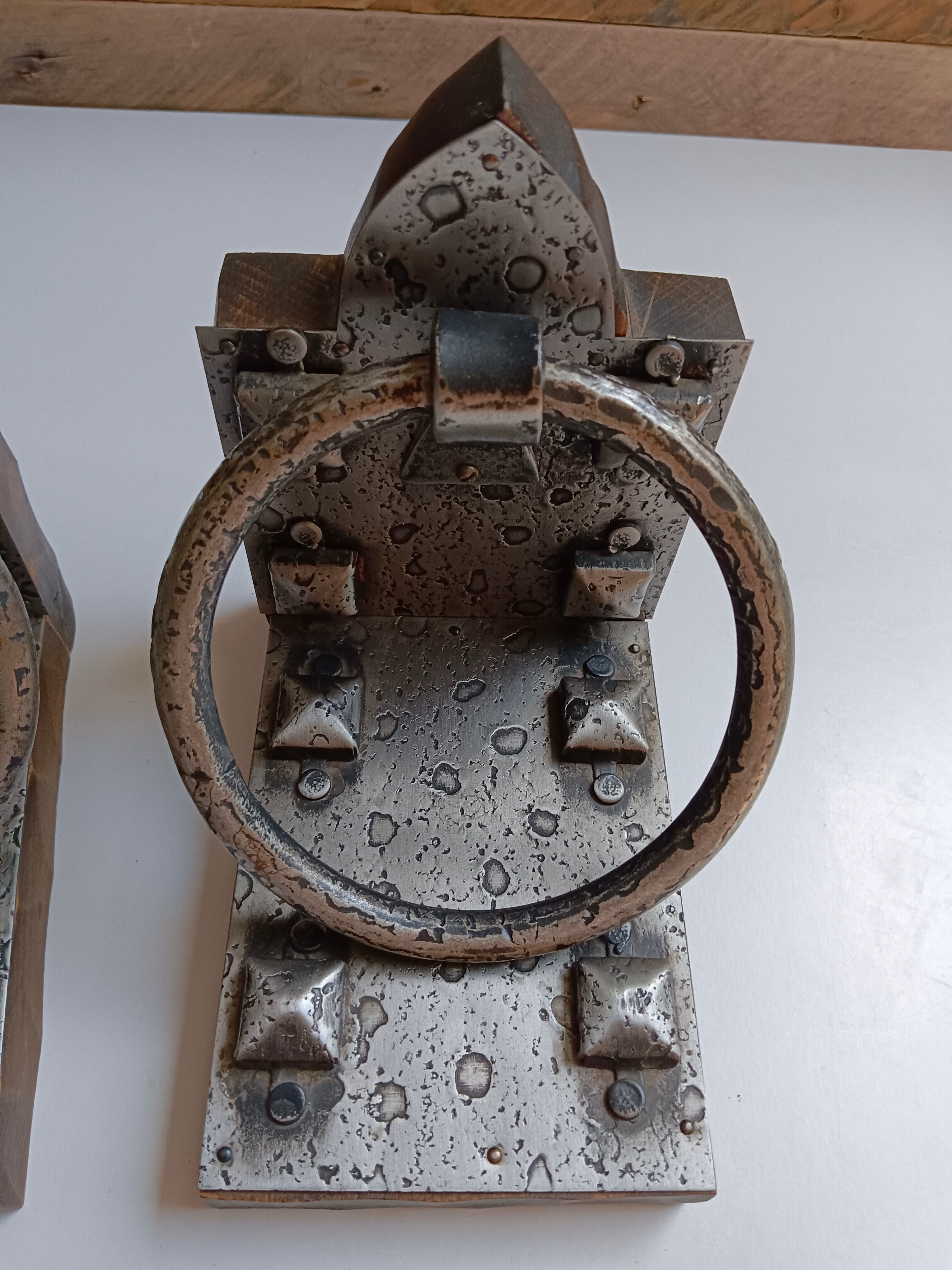 Medieval-style bookends, antique door handle.