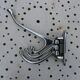 Wall-mounted coat rack in chromed metal with 4 adjustable hooks