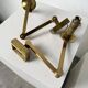 Pair of brass wall lights with articulated arms from the 70s