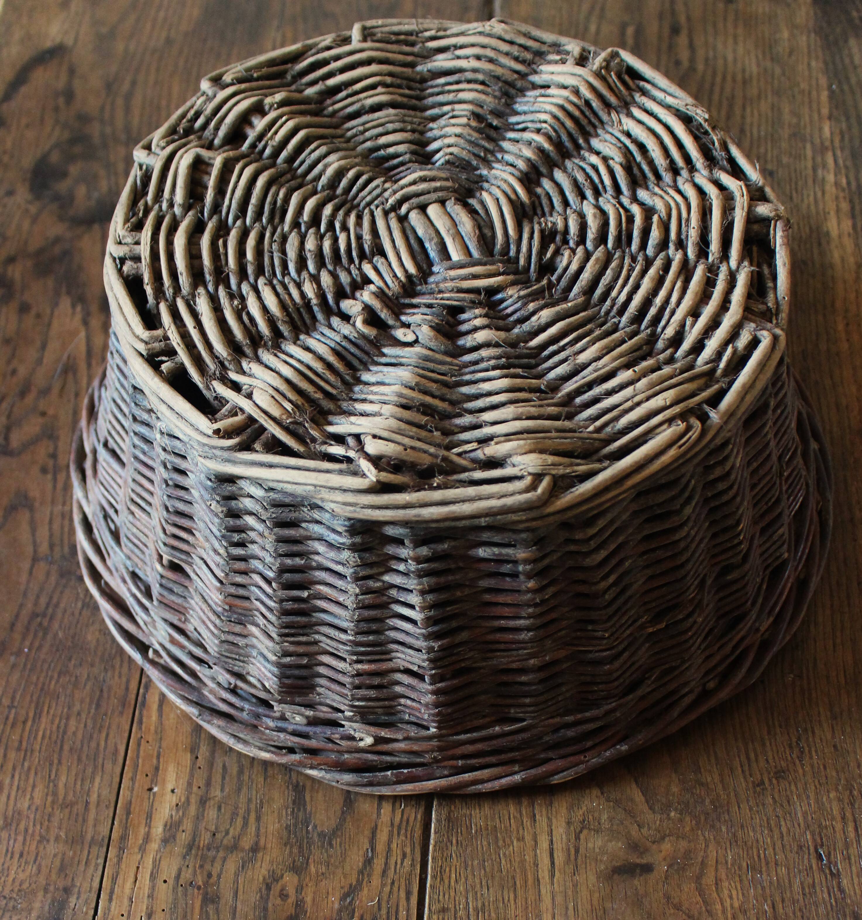 Round wicker basket with a patina
