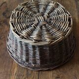 Round wicker basket with a patina