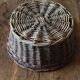 Round wicker basket with a patina