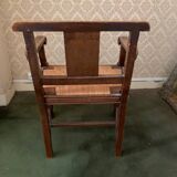 Antique armchair in carved wood and straw seat