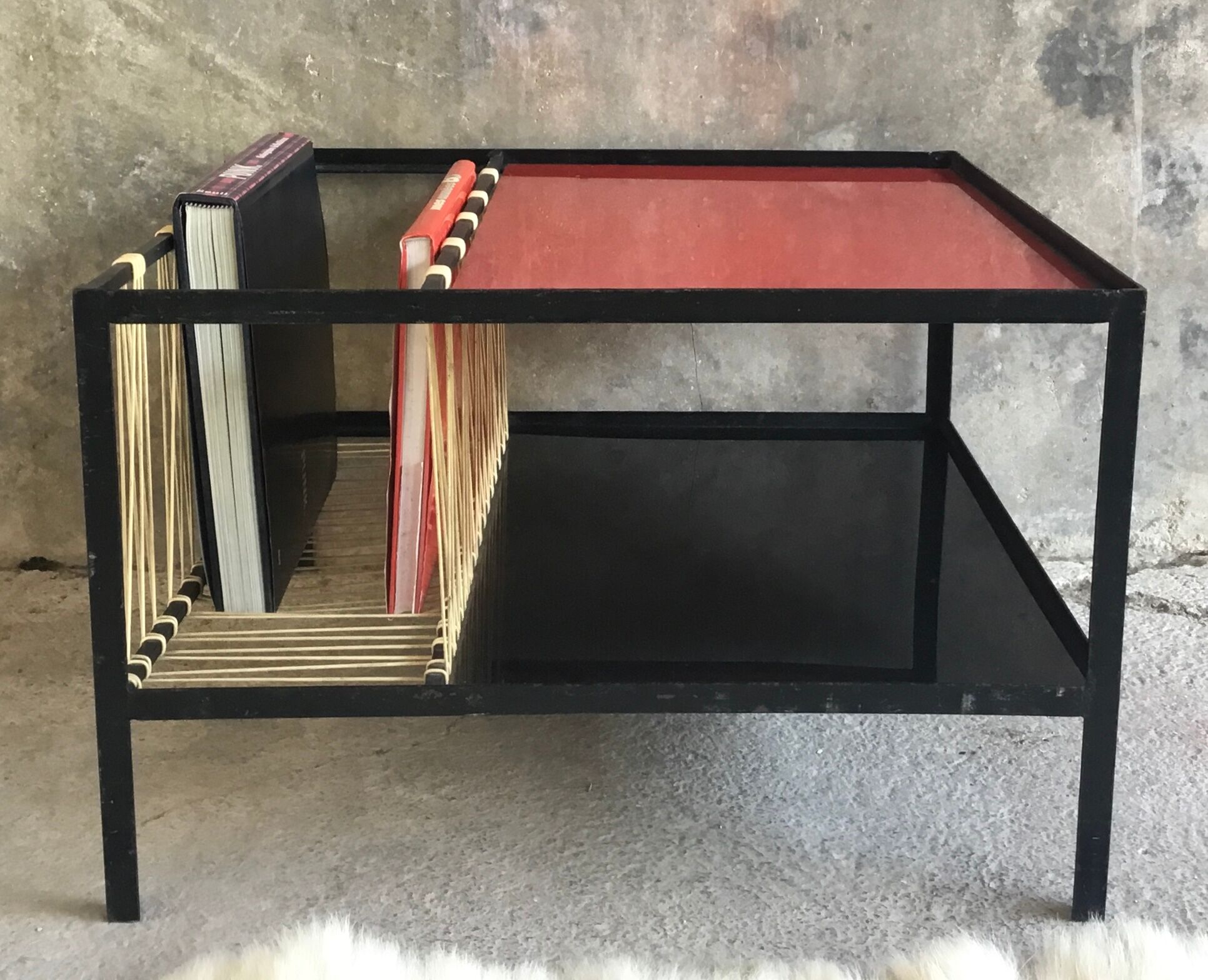 Modernist metal coffee table with a magazine rack in 1950s design.