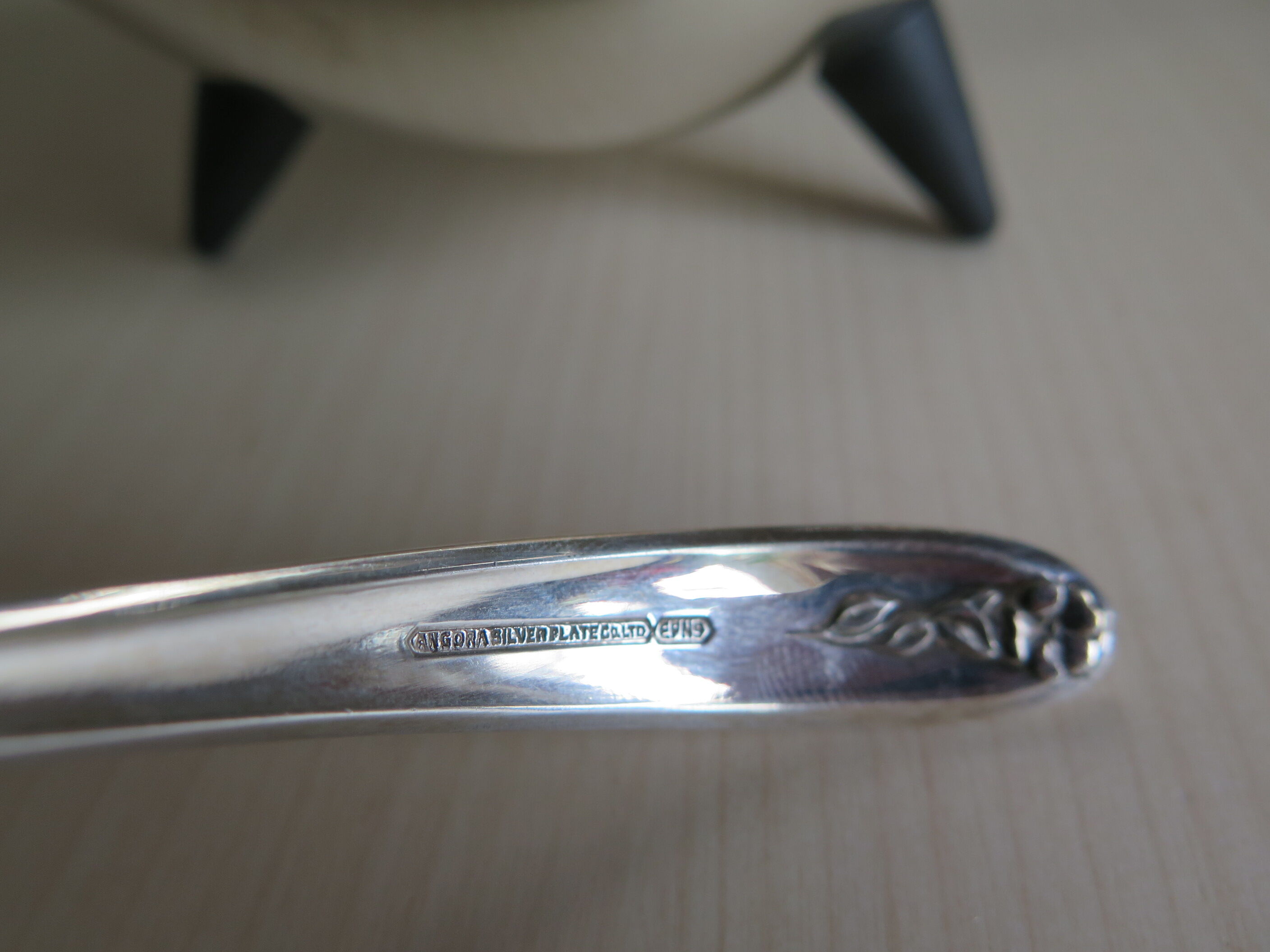 Angora tripod and silver metal spoon
