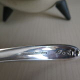 Angora tripod and silver metal spoon