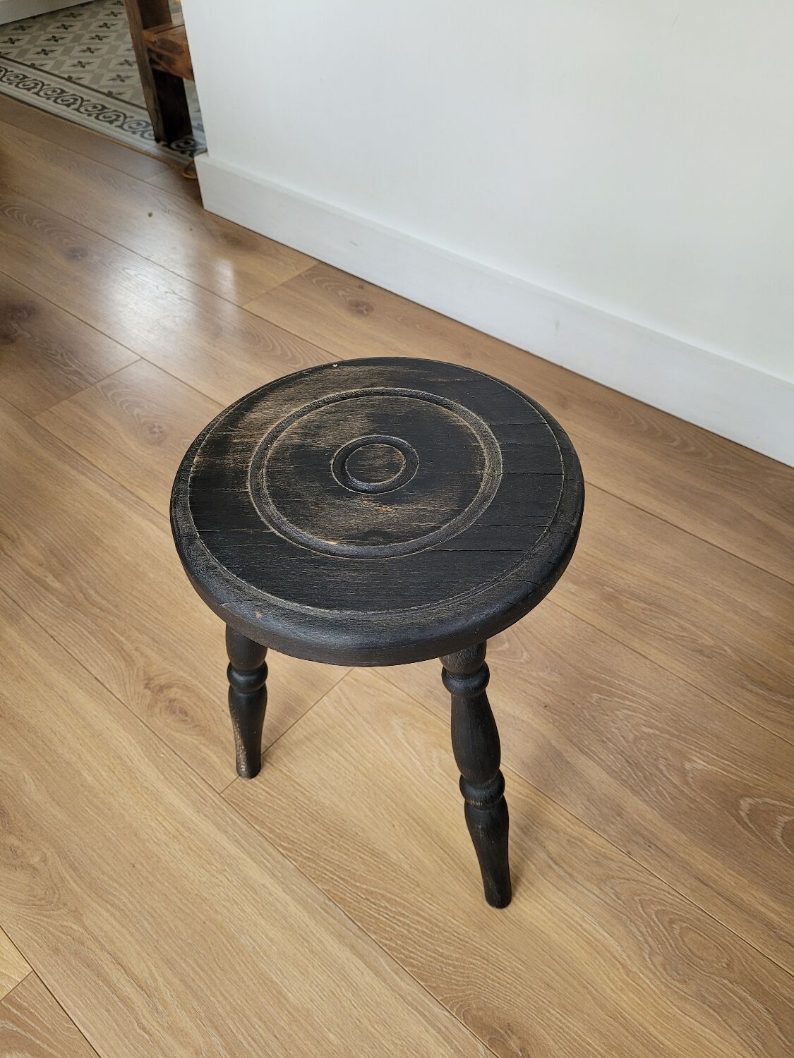 Black wooden tripod stool
