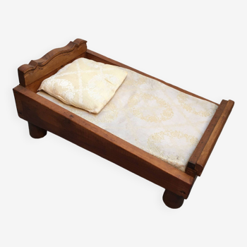 Old wooden bed for doll with mattress and pillow