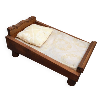 Old wooden bed for doll with mattress and pillow