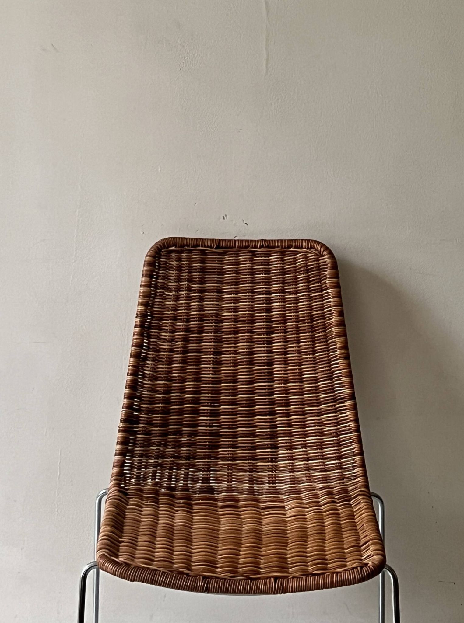 Chair made of rattan, wicker and chrome-plated metal