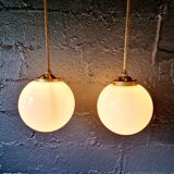 Pair of Art Deco pendant lights in brass and white opaline, 1920-30