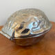 Silver metal nutcracker in the shape of a walnut