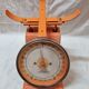 Orange metal household scale from 1970