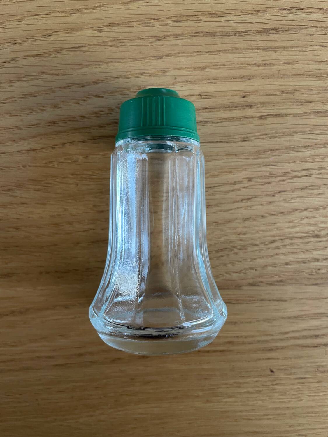 Vintage salt shaker with green Bakelite cap