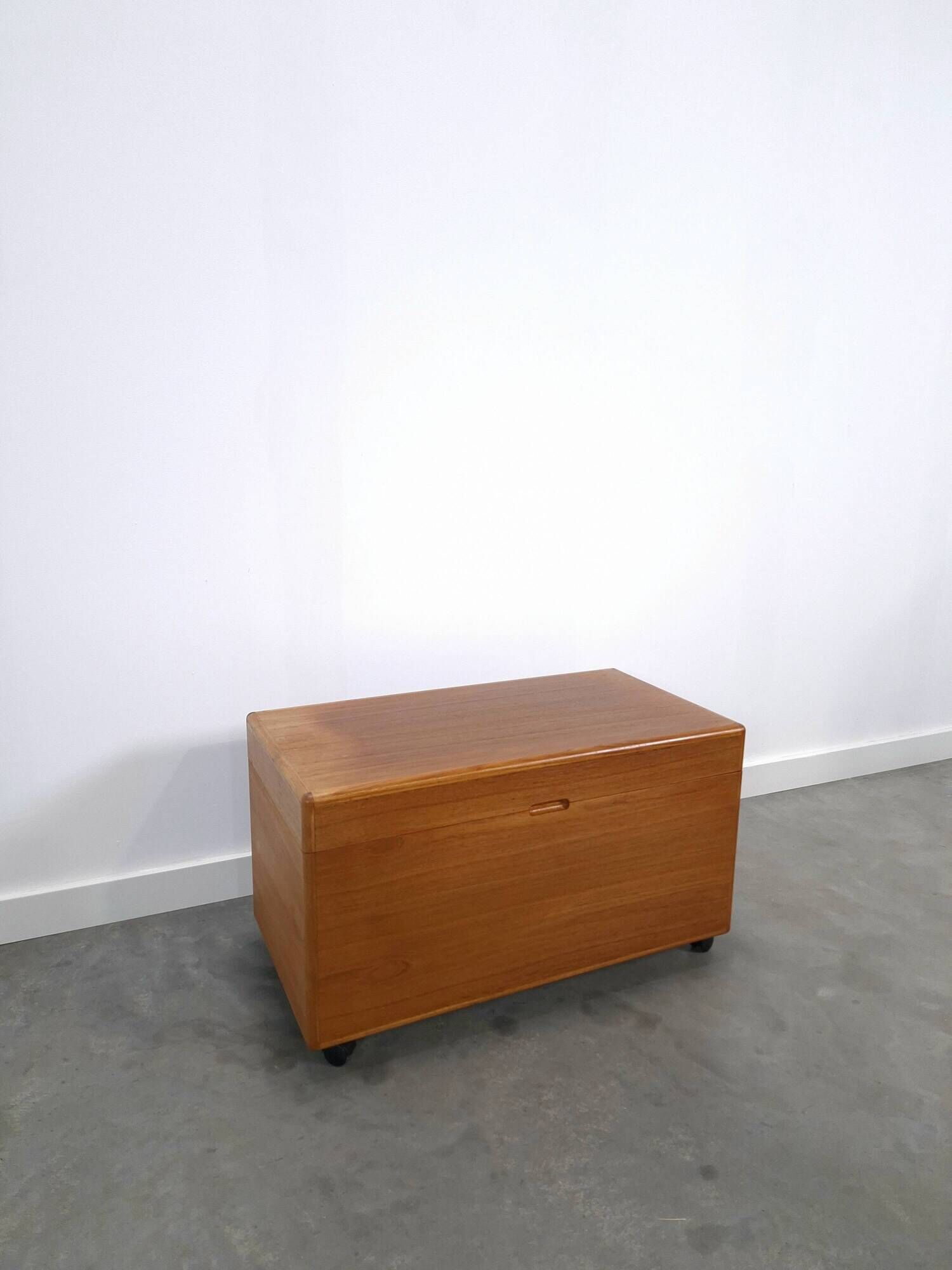 Vintage teak Danish chest with a lid on wheels, toy chest.