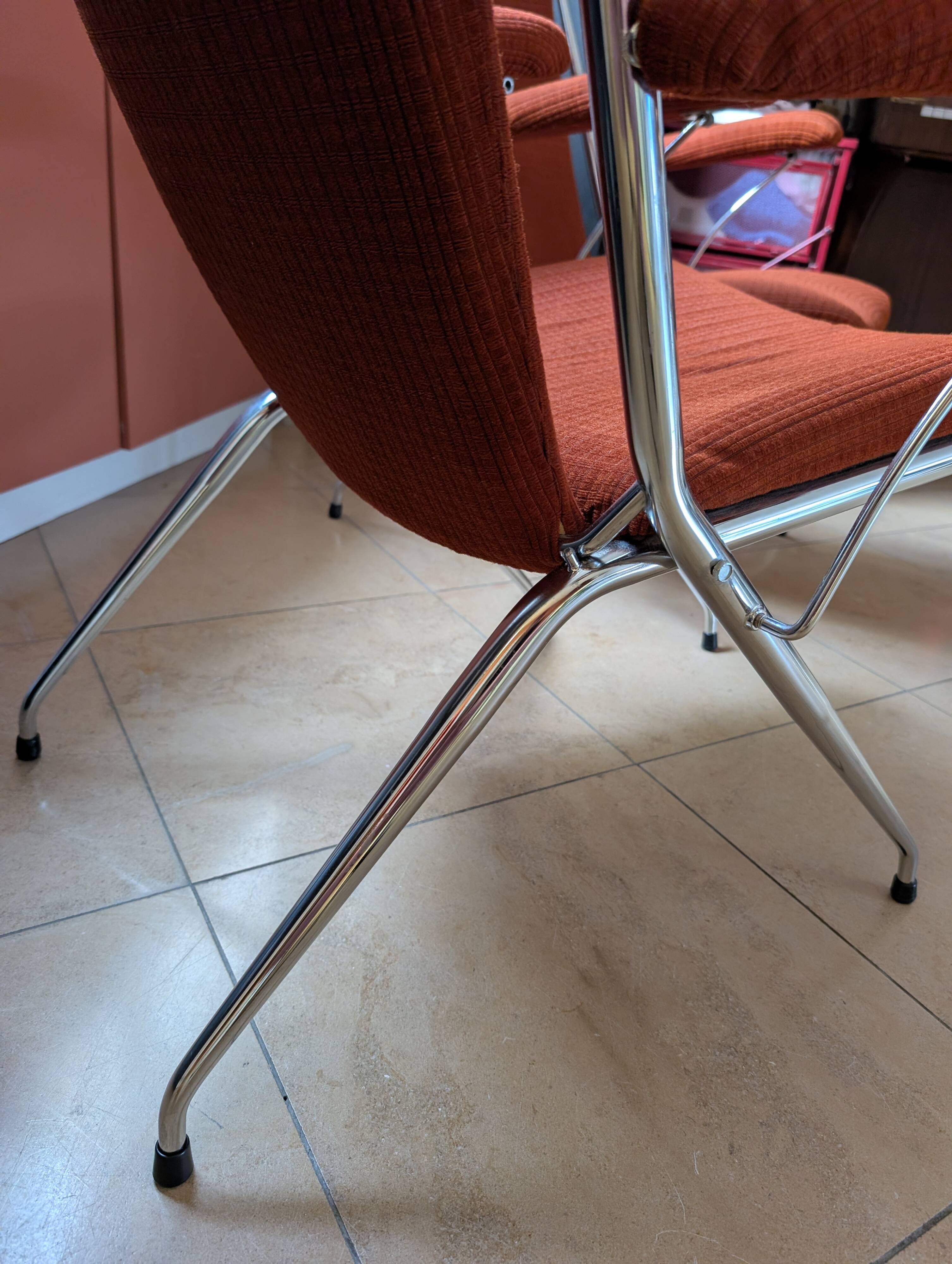 Pair of vintage folding chairs in terracotta fabric.