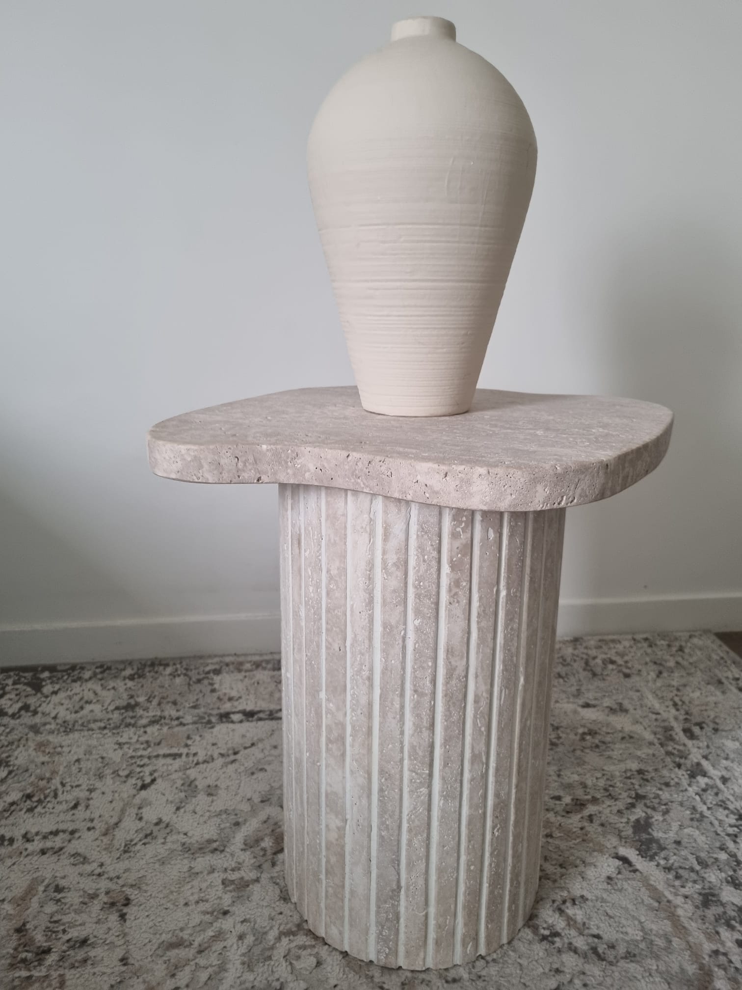 Alpha side table irregular natural travertine ribbed foot