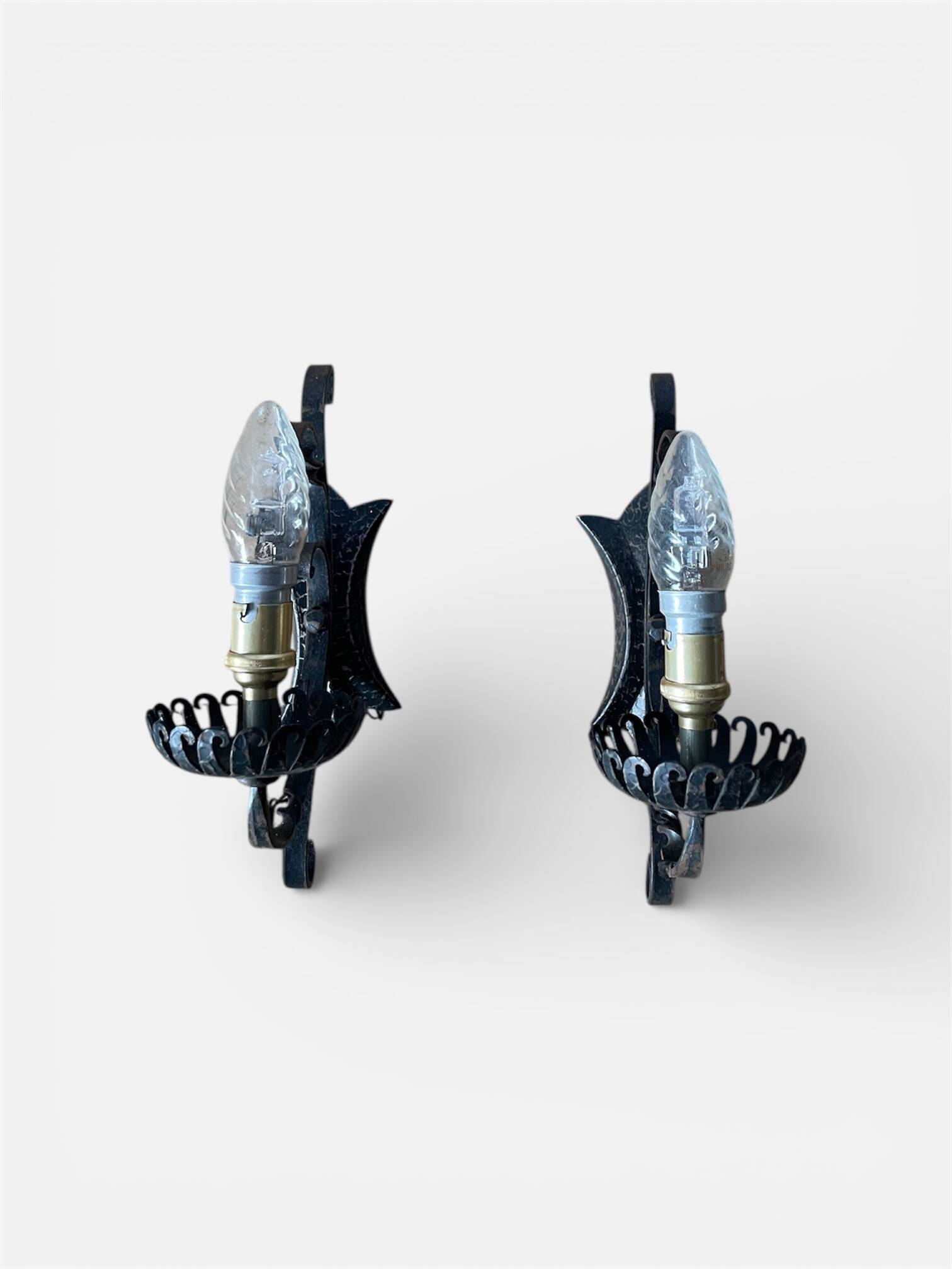 Vintage wrought iron wall lights in rustic gothic style.