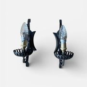 Vintage wrought iron wall lights in rustic gothic style.