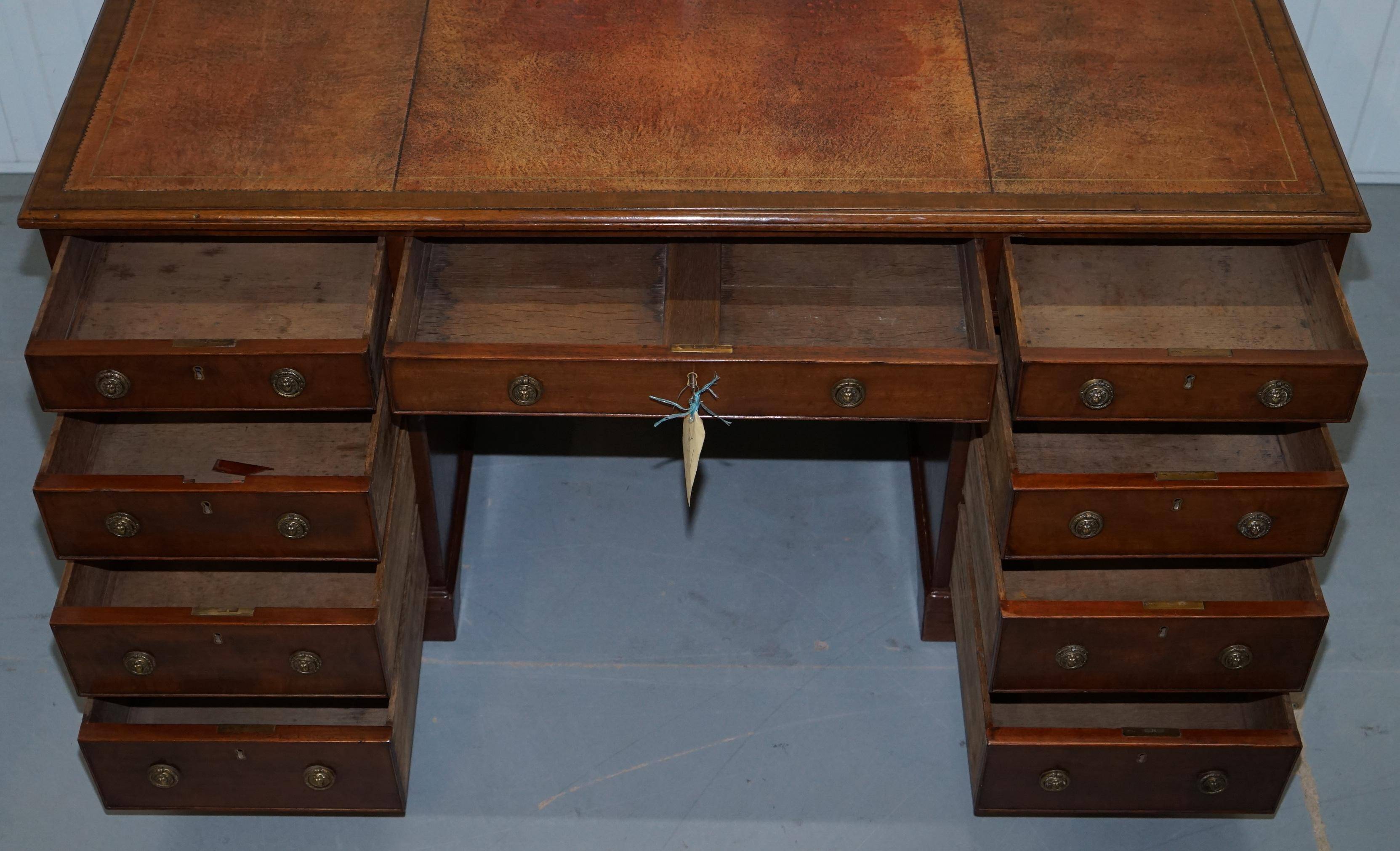 Double-sided partner's desk in walnut, George III, circa 1780, with lion head handles.