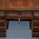 Double-sided partner's desk in walnut, George III, circa 1780, with lion head handles.