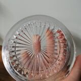 Vintage pressed molded glass plate under bottle
