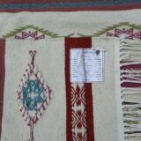 Tribal bohemian kilim rug with geometric pattern in wool.