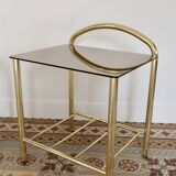Pair of bedside tables with gold metal and mirrored glass top.