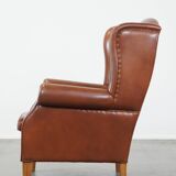Cognac-colored leather wingback chair in English style